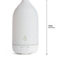 A white essential oil diffuser with dimension markings showing a height of 8 in (19 cm) and a diameter of 3.5 in (9 cm) on a white background. dōTERRA Laluz Diffuser with Lemon and Lavender
