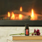 A small bottle of doTERRA cat spray placed on a stack of books in front of a warm fireplace, with a flower resting beside it. dōTERRA Harvest Spice Blend | Canada