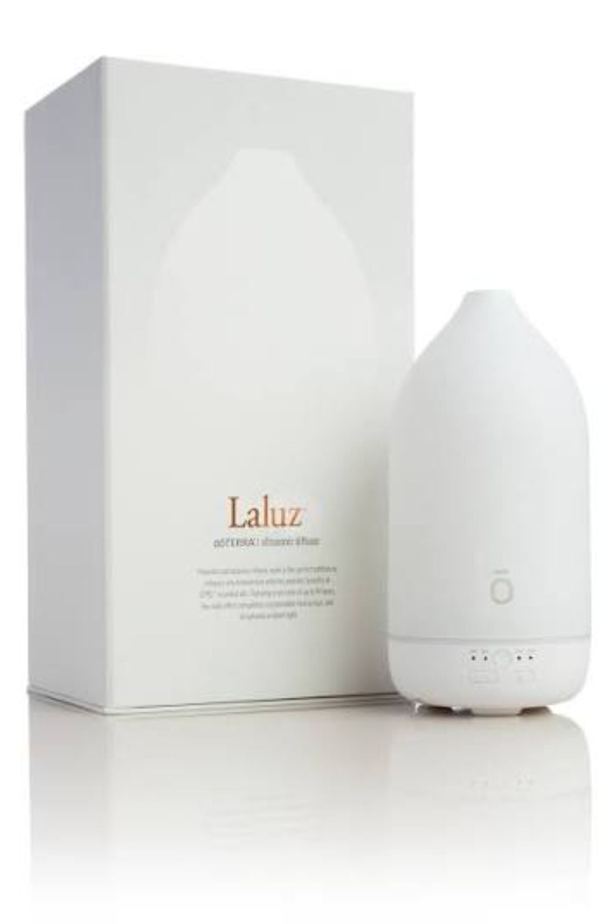 A white essential oil diffuser bottle standing next to its white packaging box, which features the brand name 'Laluz' in gold text. dōTERRA Laluz Diffuser with Peppermint & Wild Orange